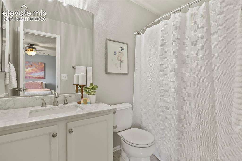 Image 21 of 46: Bathroom featuring a vanity with a white countertop and integrated sink, a