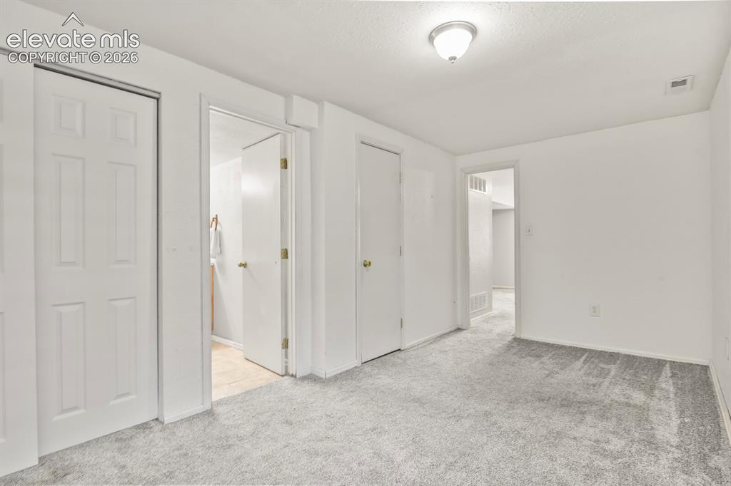 Image 31 of 46: Basement bedroom with adjoining full bath.