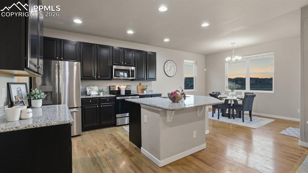 Image 13 of 50: View into the Living Room and Kitchen from the Office.