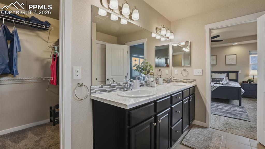 Image 27 of 50: Upper level Primary Bathroom with dual sink vanity, enclosed tiled shower w