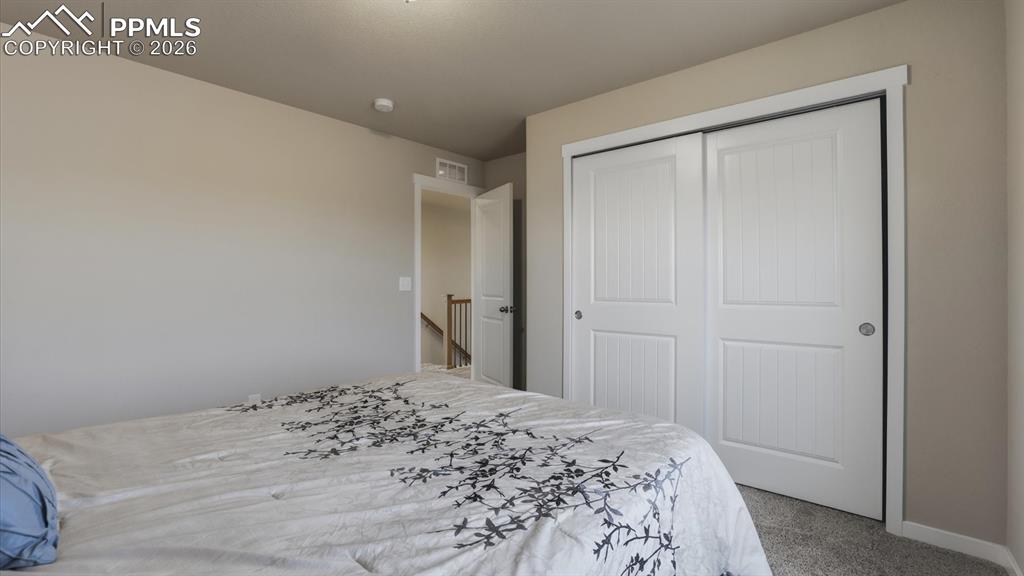 Image 31 of 50: Upper Level Laundry Room with with washer and dryer that stays.