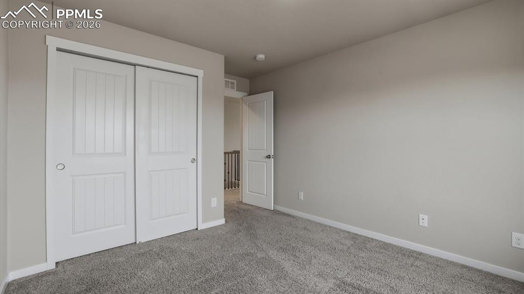 Image 33 of 50: Upper Level Bedroom #2 has a generous closet.