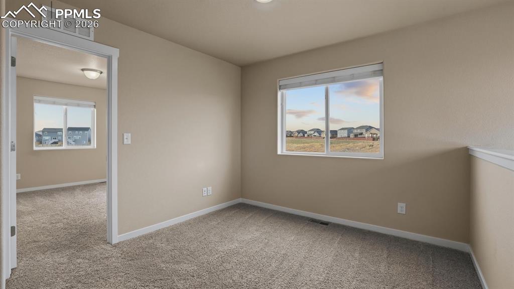 Image 38 of 50: Upper Level Bedroom #4 with neutral carpet.