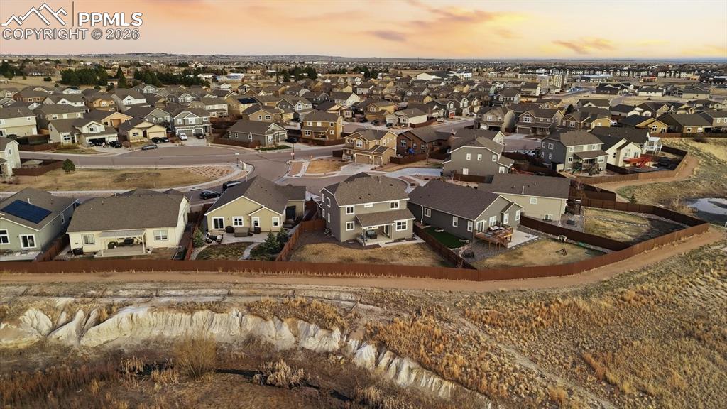 Image 50 of 50: Large fenced yard with auto sprinklers, a covered patio, and beautiful moun