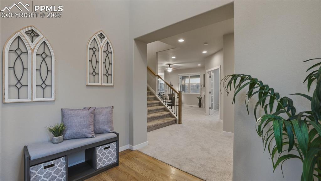 Image 6 of 50: Covered, arched entry with stone accent.