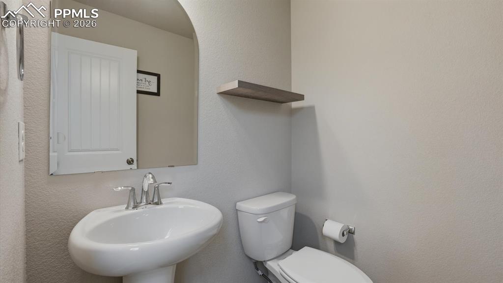 Image 8 of 50: Interior Entry with iron rails to the upper level.