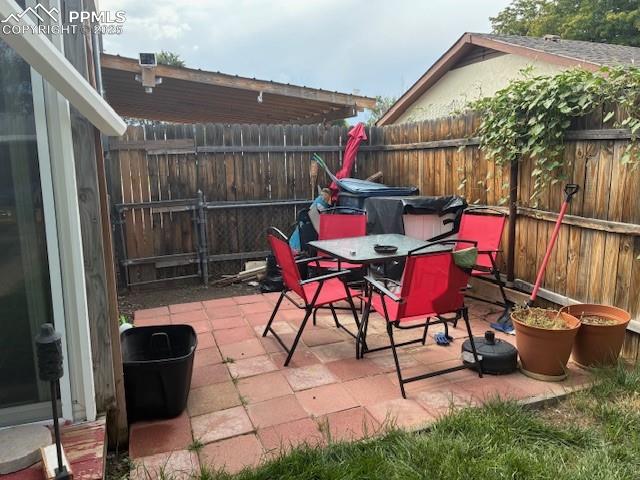 Image 12 of 12: View of patio with outdoor dining space