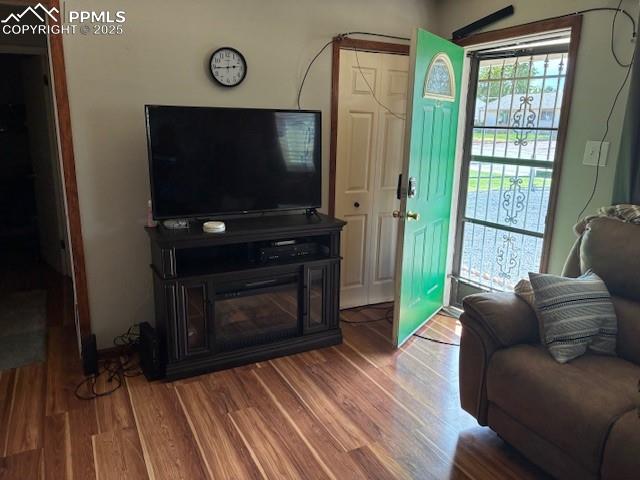 Image 2 of 12: Living area featuring wood finished floors