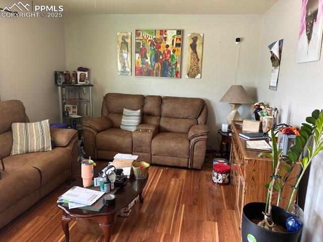 Image 3 of 12: Living room with wood finished floors