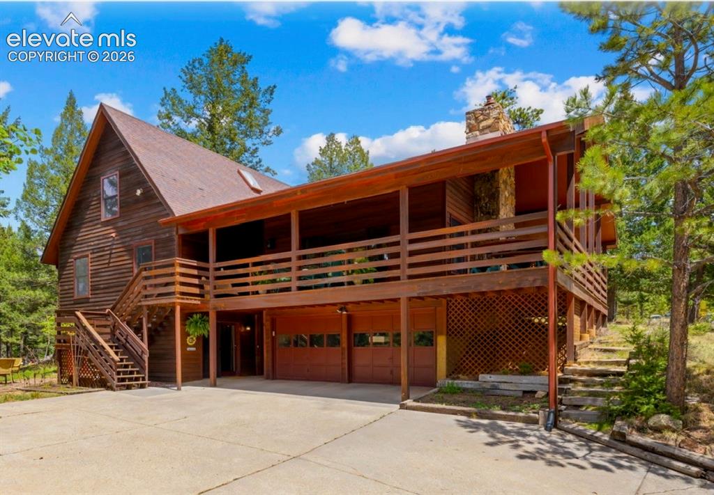 Caption: Welcome Home! Woodland Park Beauty!
Redwood siding and redwood Covered Wraparound Deck!