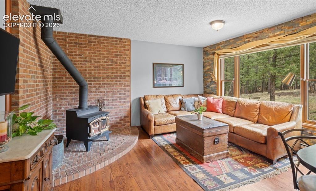 Image 11 of 42: Main level hearth room adjoins the kitchen  * Genuine Hardwood Floors with 