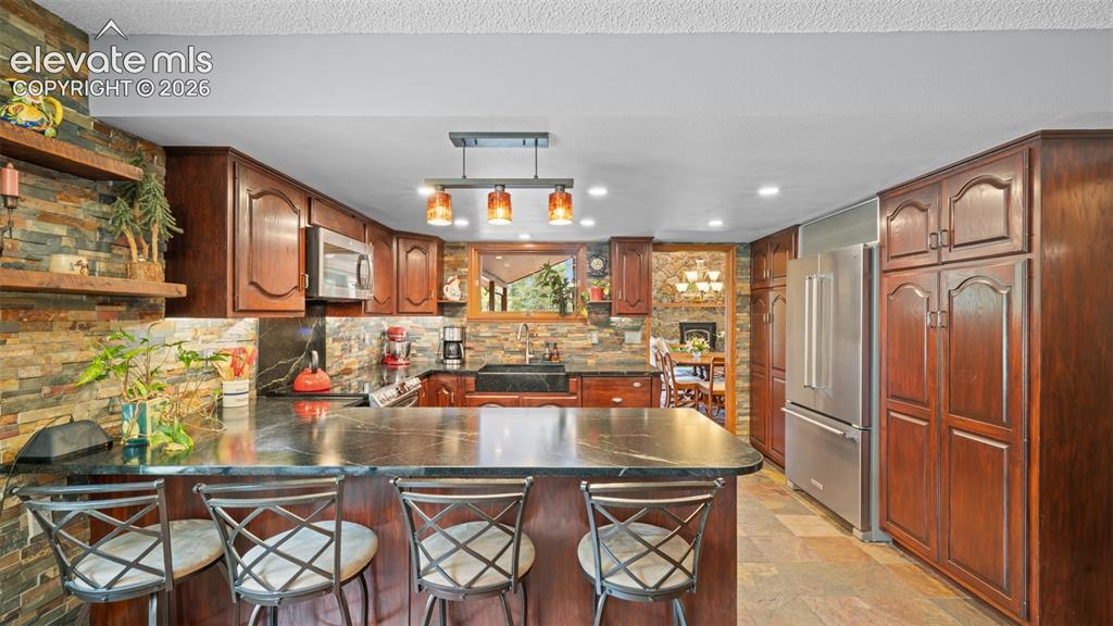 Image 13 of 42: Soapstone Breakfast Bar!
