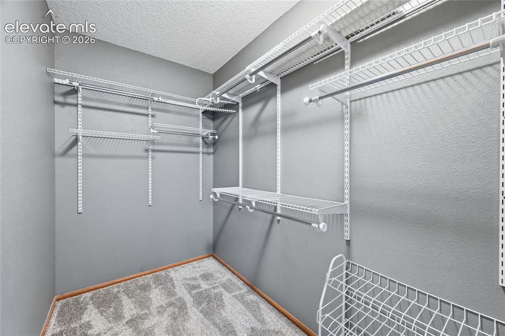Image 21 of 50: Second primary bedroom walk-in closet