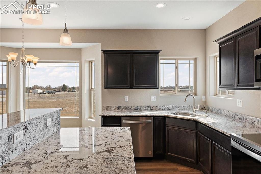 Image 13 of 45: Kitchen featuring a sink, appliances with stainless steel finishes, light s