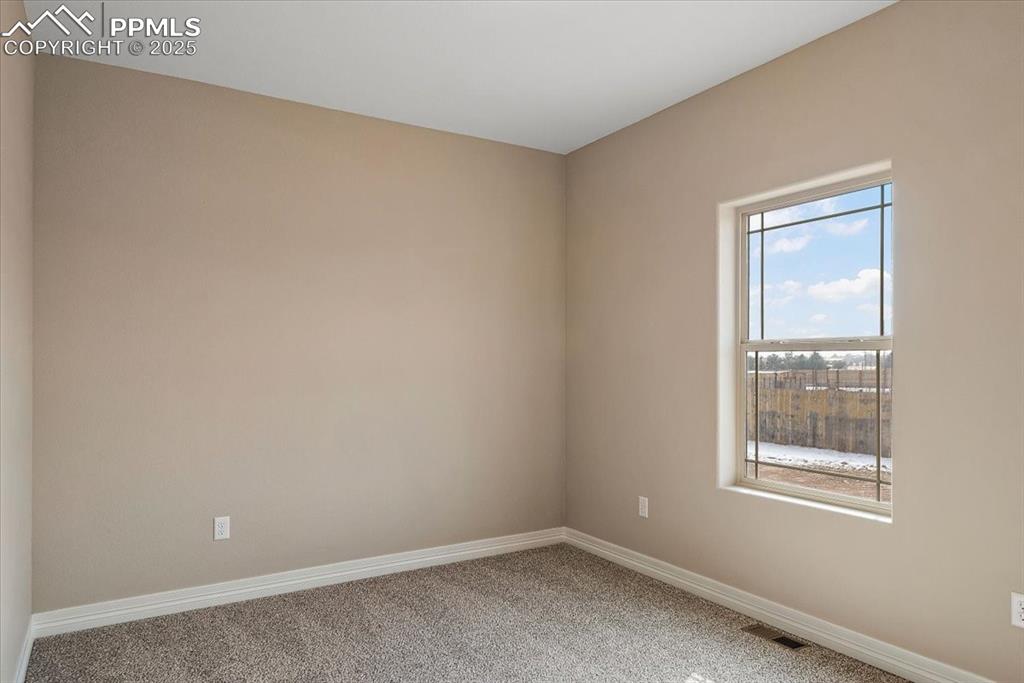 Image 19 of 45: Carpeted spare room with visible vents and baseboards