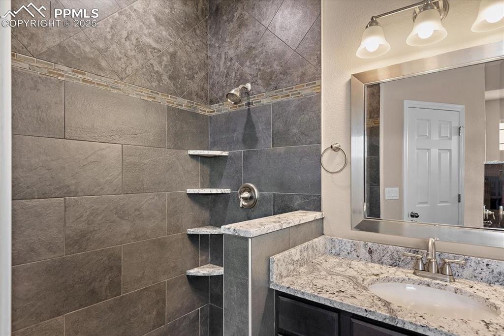 Image 28 of 45: Bathroom with vanity and walk in shower