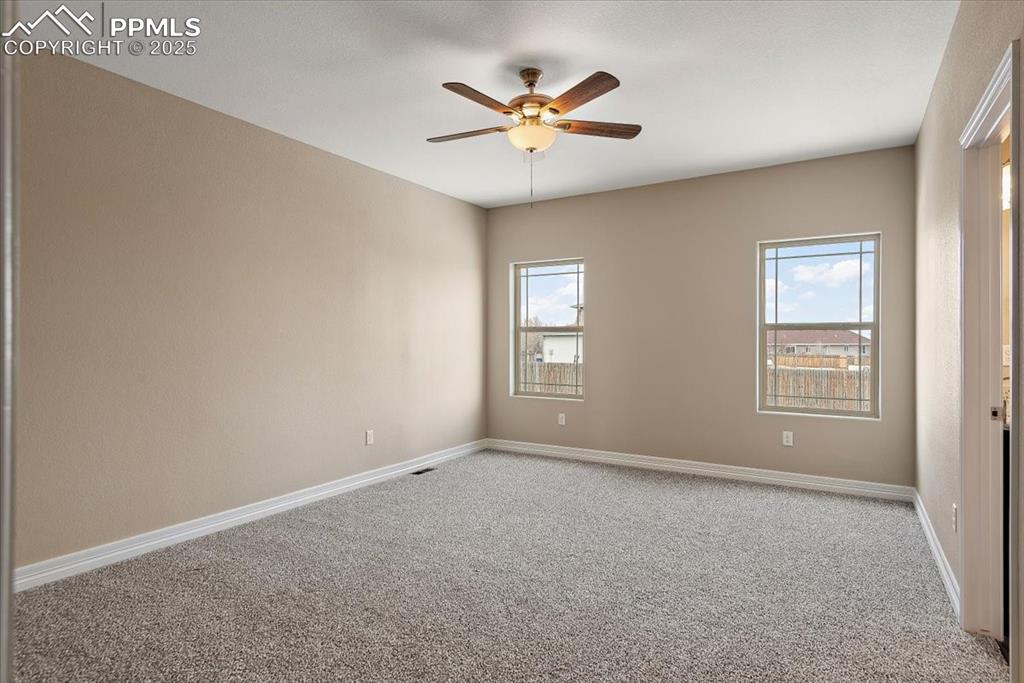 Image 33 of 45: Spare room featuring carpet flooring, plenty of natural light, and baseboar