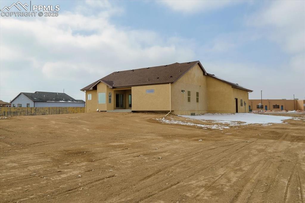 Image 40 of 45: Back of property featuring stucco siding