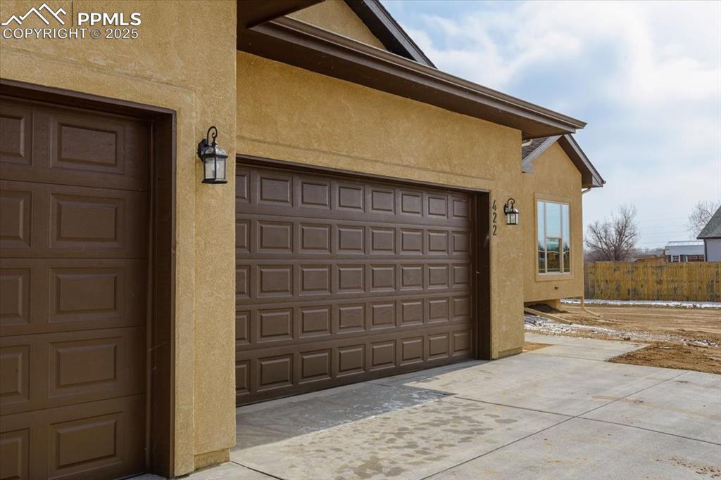 Image 43 of 45: Garage with concrete driveway