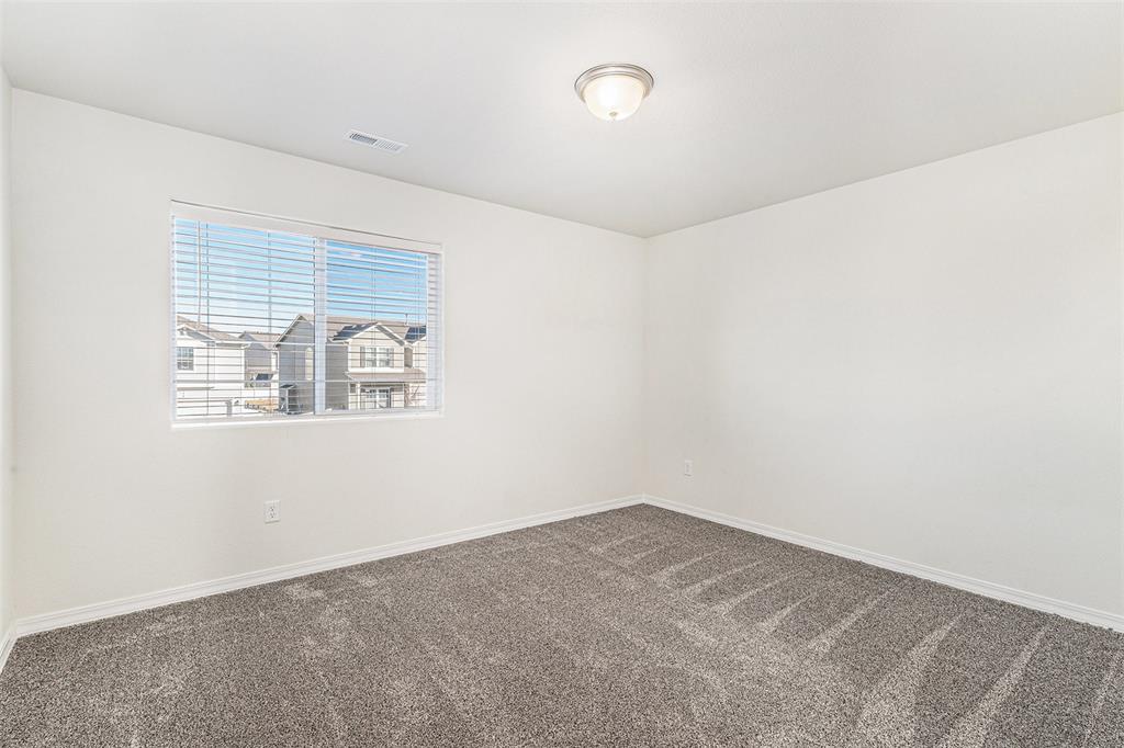 Image 19 of 33: Carpeted empty room with baseboards