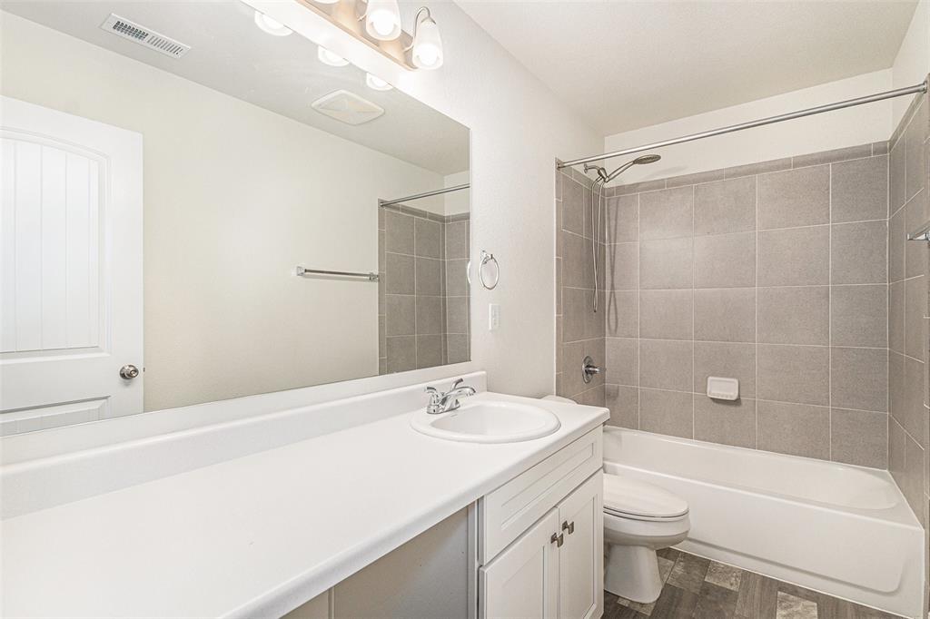 Image 21 of 33: Full bathroom featuring vanity, shower / bathtub combination, and dark wood