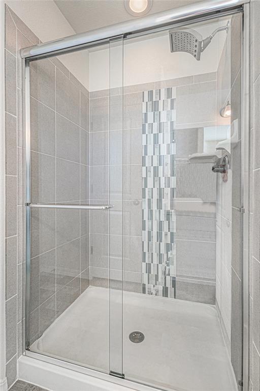 Image 27 of 33: Bathroom with a stall shower