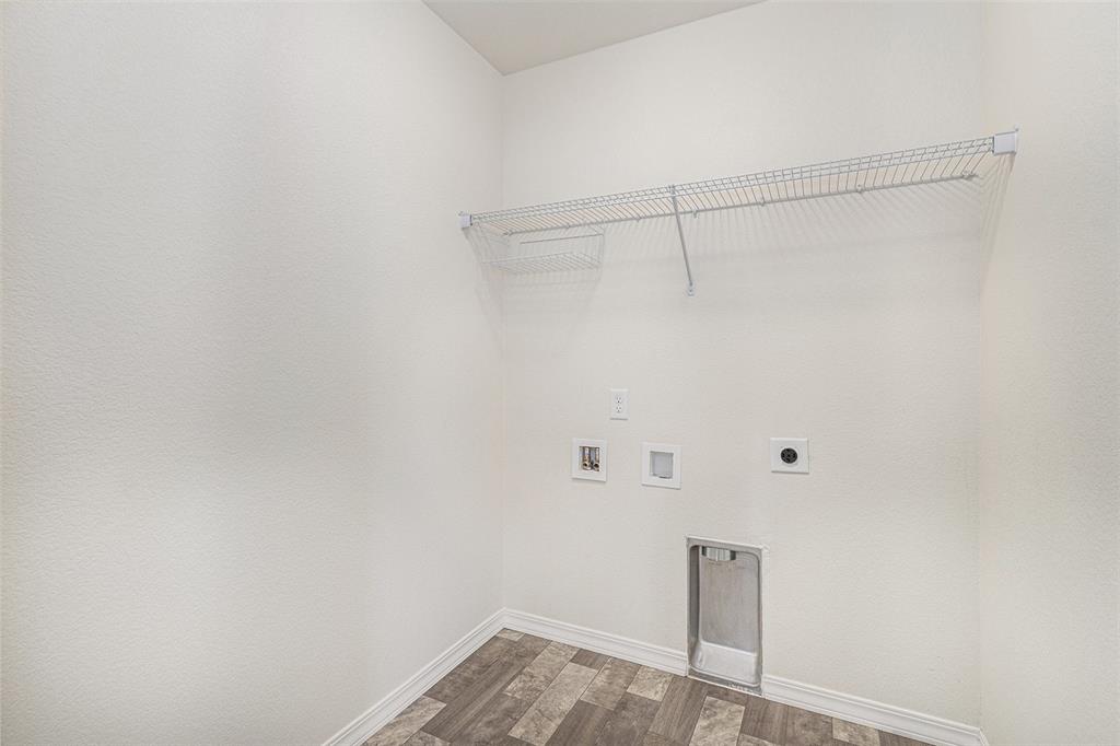 Image 28 of 33: Laundry room with dark wood-type flooring, washer hookup, and electric drye