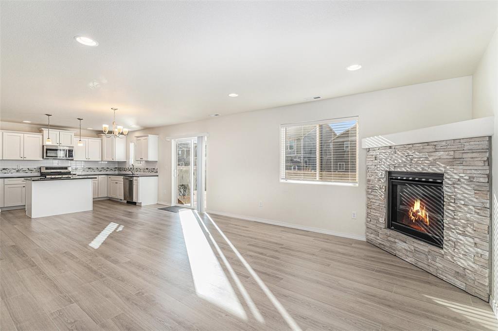 Image 8 of 33: Unfurnished living room featuring a chandelier, light wood-style floors, a