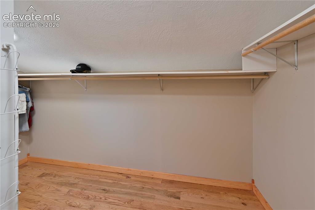 Image 19 of 40: Wood-finish flooring with baseboard trim