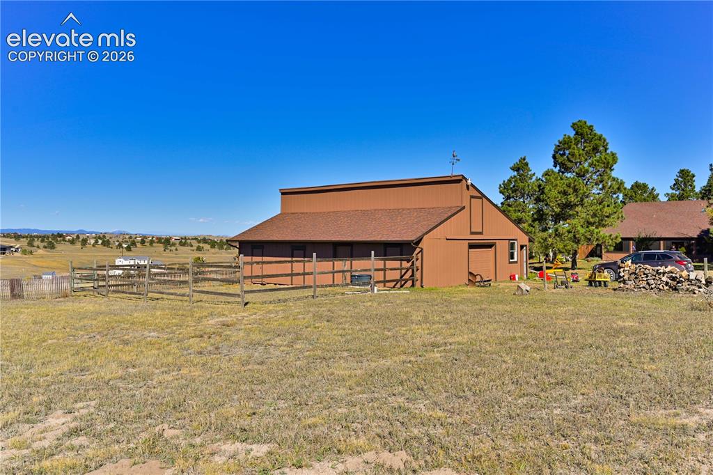 Image 36 of 40: Barn structure with a brown exterior and a gabled roof