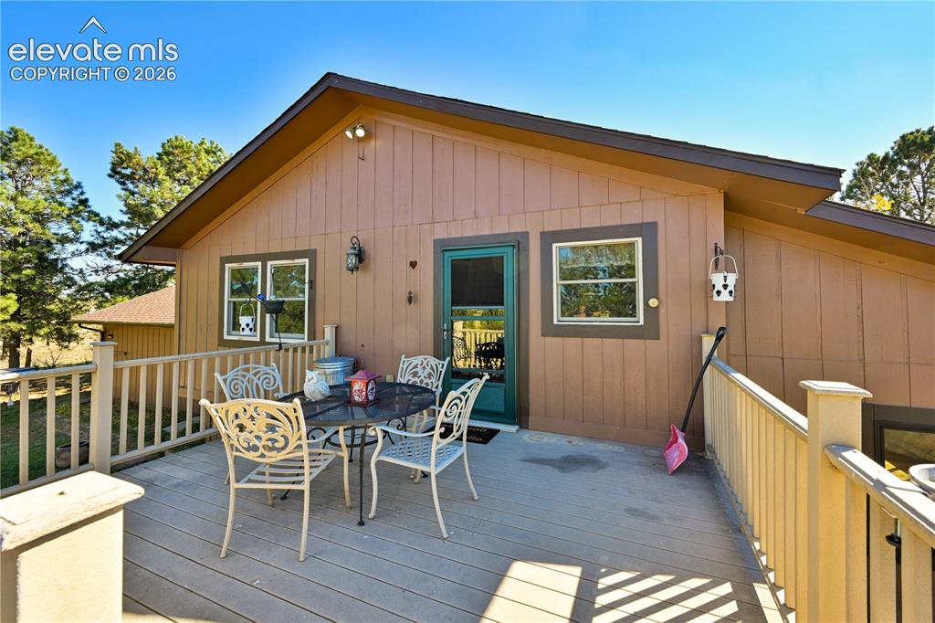 Image 8 of 40: Expansive outdoor deck with wood-finish flooring, featuring a solid railing