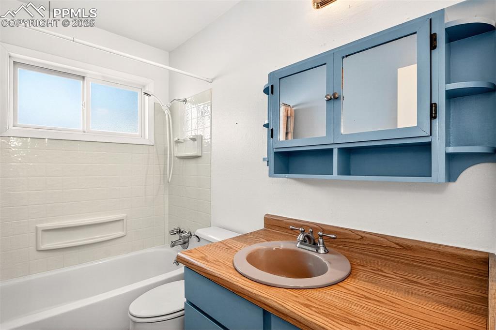 Image 11 of 21: Bathroom with tub / shower combination and vanity