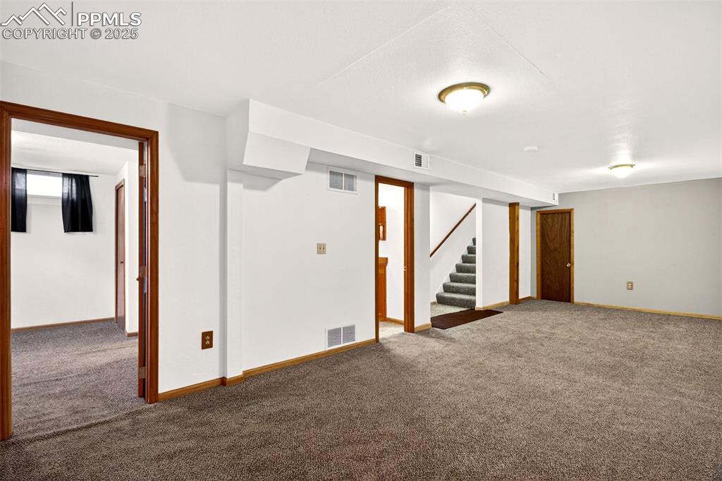 Image 13 of 21: Basement Family Room With Bedroom #4 and Bathroom. Plenty of Storage In Th