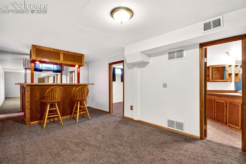 Image 14 of 21: Basement Family Room Looking Into The Bedroom And Attached Bathroom