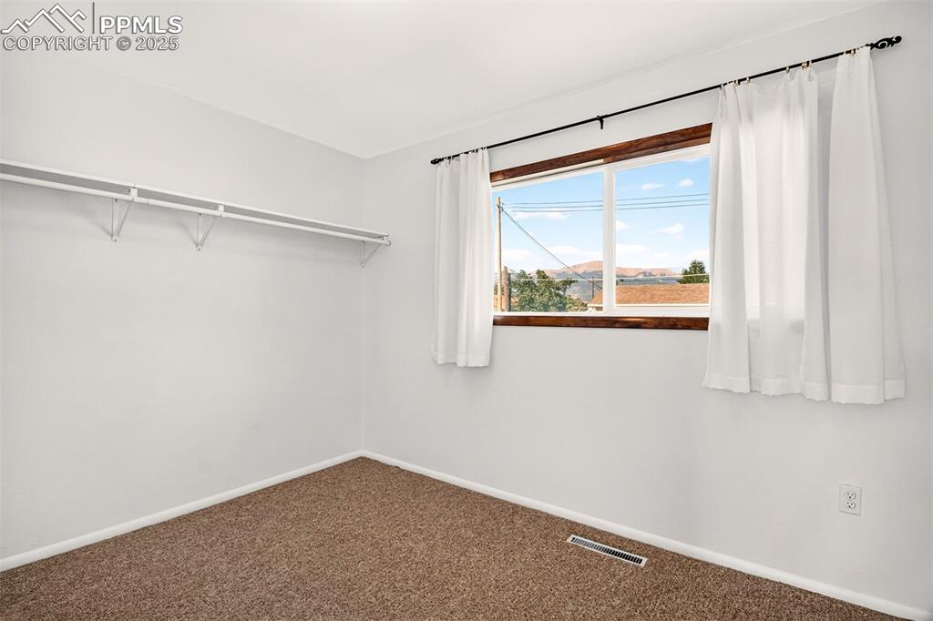 Image 9 of 21: Main Level Bedroom #2, Hardwood Flooring Under The Carpet