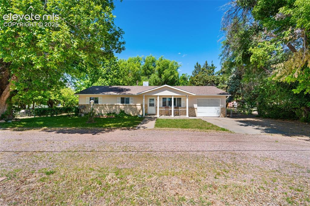 Image 1 of 36: Ranch-style residence featuring a covered front porch with white columns, a