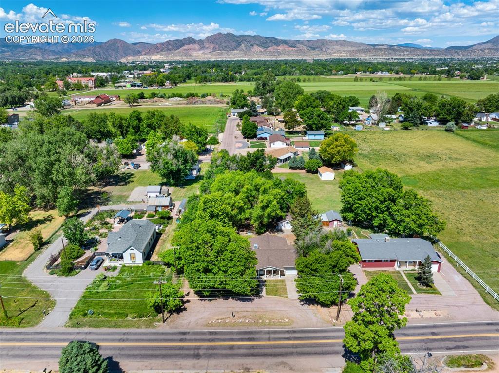 Image 2 of 36: Expansive property featuring a flat landscape with mountain backdrop, matur