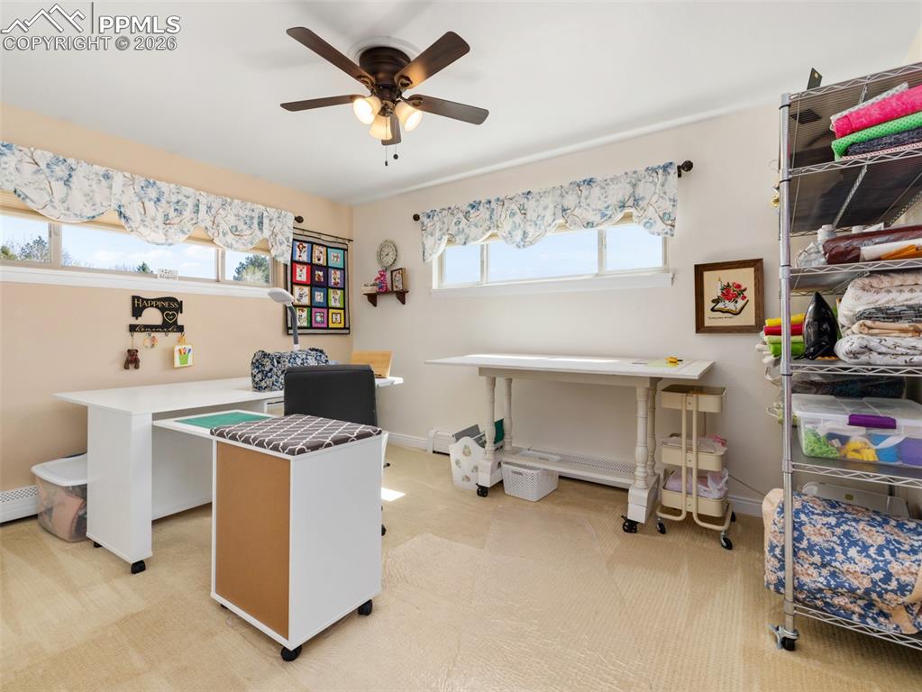 Image 15 of 39: Bedroom with light carpet and a ceiling fan
