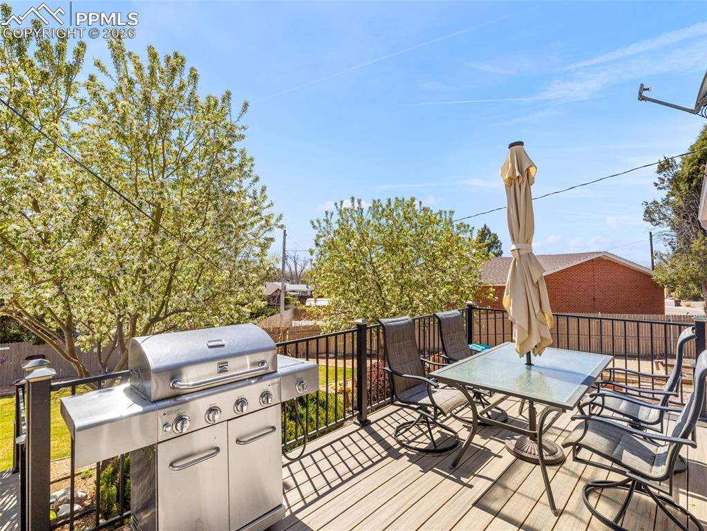 Image 26 of 39: Trex deck featuring outdoor dining space and area for grilling