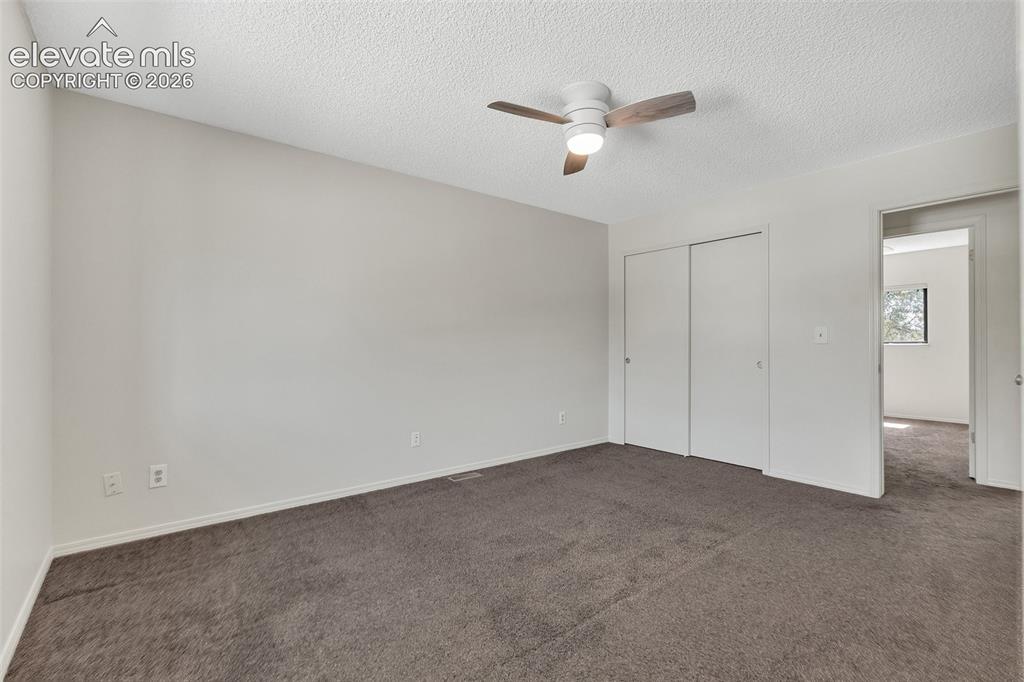 Image 16 of 33: Neutral wall paint, ceiling fan with light fixture, carpeted flooring, and 