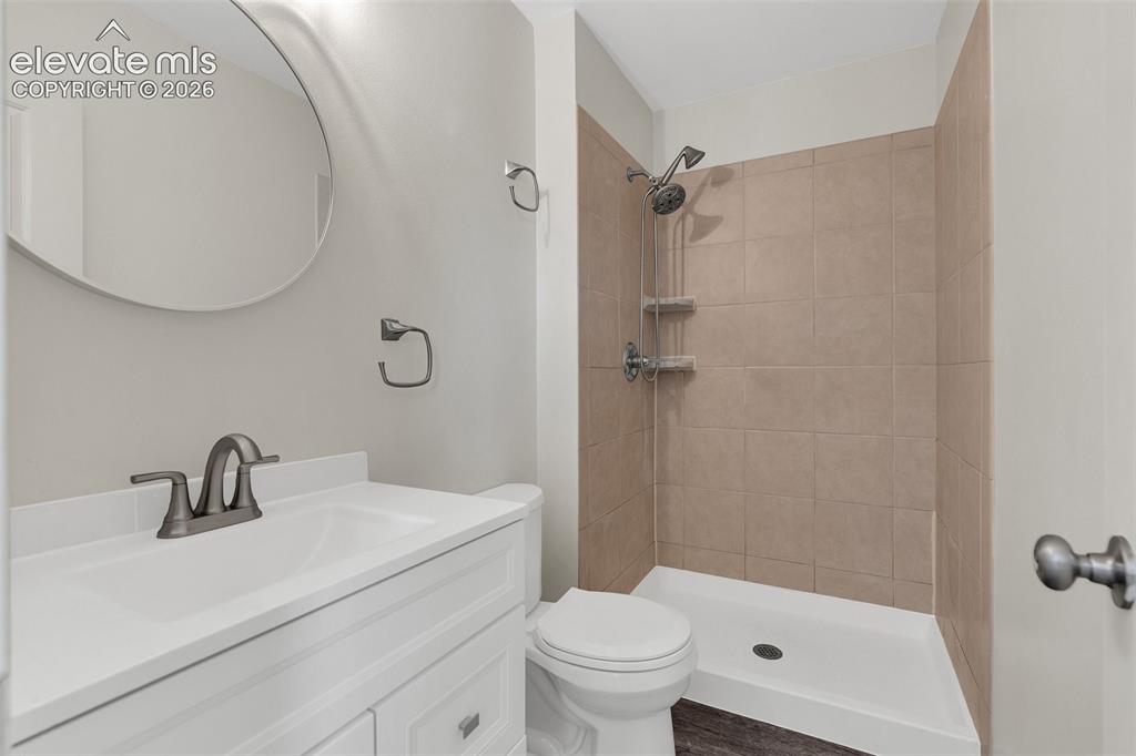 Image 17 of 33: White vanity with a single basin sink and brushed nickel faucet, circular w