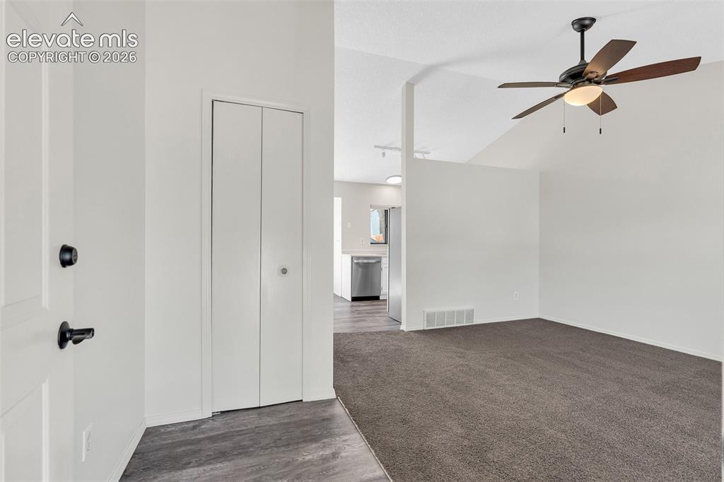 Image 3 of 33: Spacious primary living area featuring neutral wall finishes, ceiling fan w