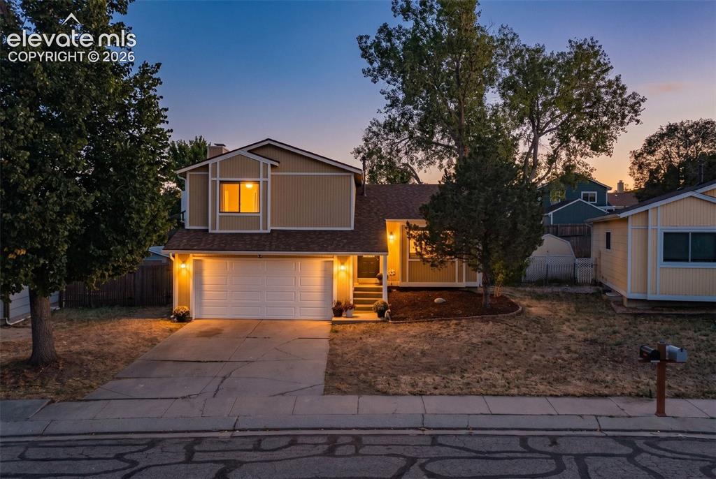 Image 33 of 33: Two-story residence with a two-car garage, concrete driveway, and front yar