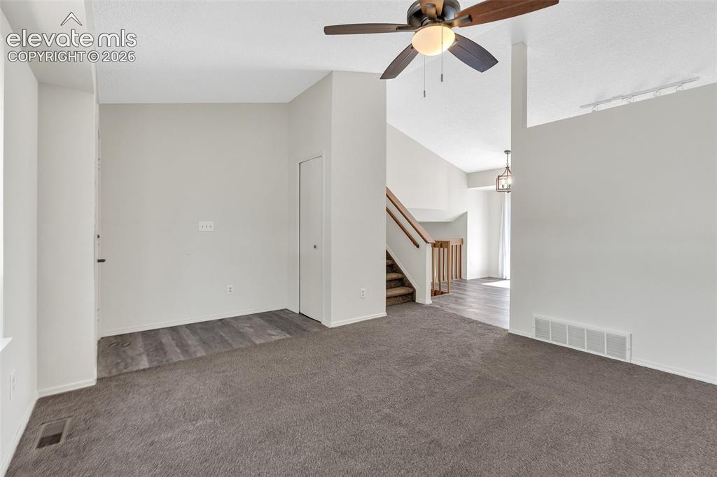 Image 6 of 33: Vaulted ceiling, ceiling fan with integrated lighting, wood-finish flooring
