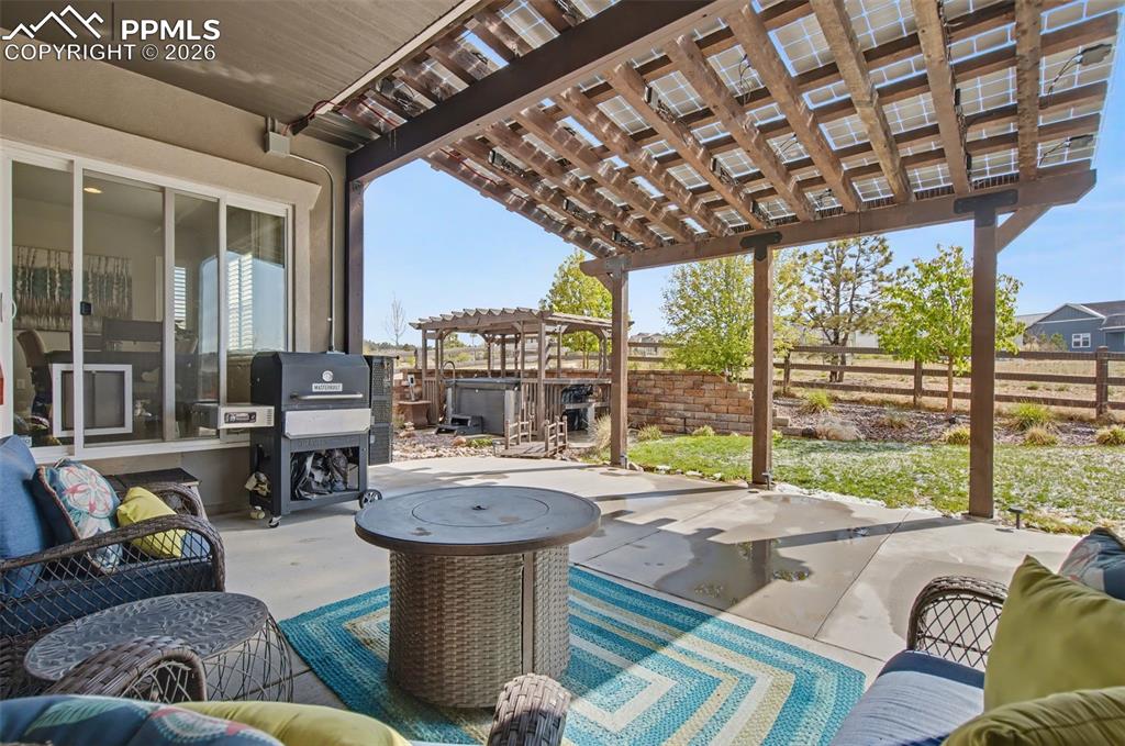 Image 38 of 50: Covered back patio featuring custom solar setup for the roof!