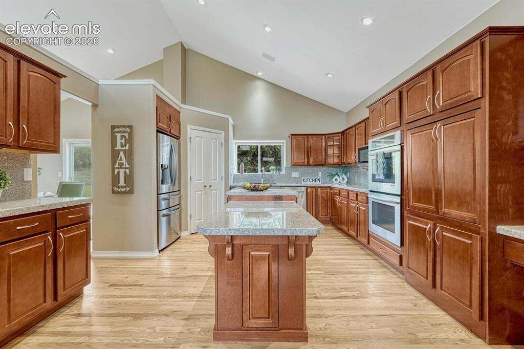 Image 12 of 50: Large kitchen with ample cabinetry, stainless appliances, and pantry