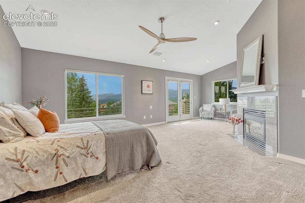 Image 18 of 50: Gigantic primary bedroom with 2-way gas fireplace and VIEWS