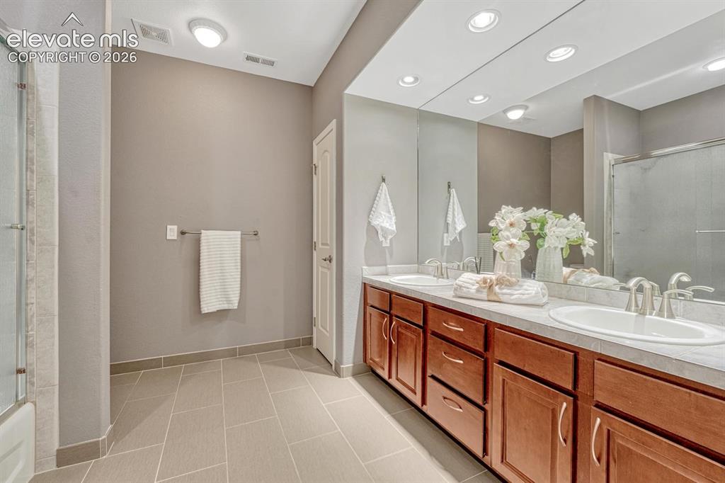 Image 35 of 50: Huge secondary bathroom with linen closet.