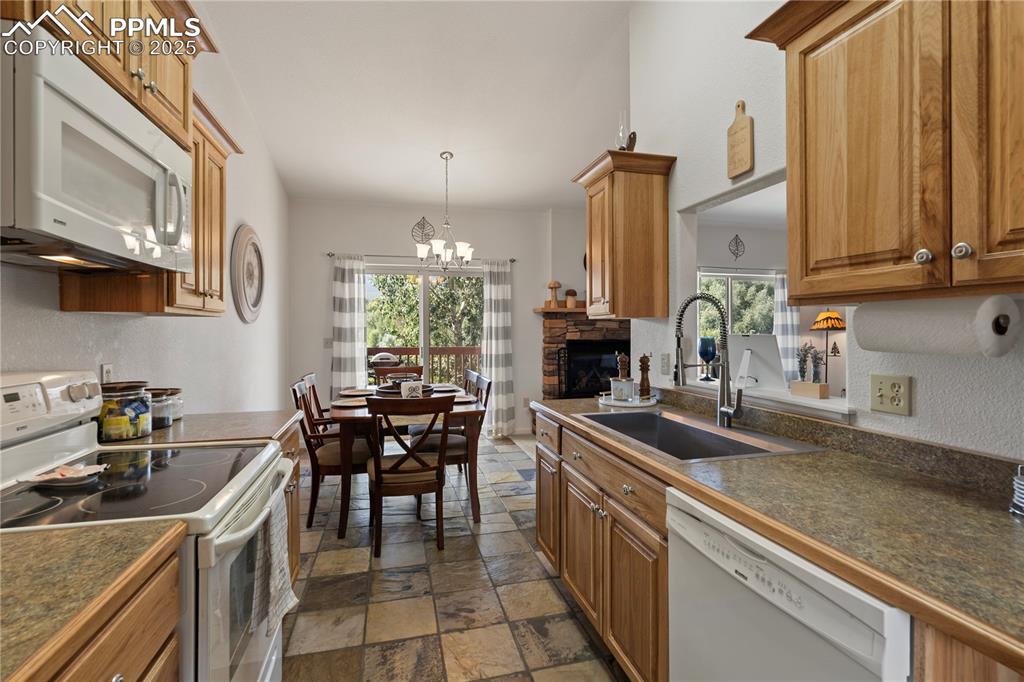Image 10 of 27: The dining space is adjacent to the kitchen, has gorgeous tile floors, and 