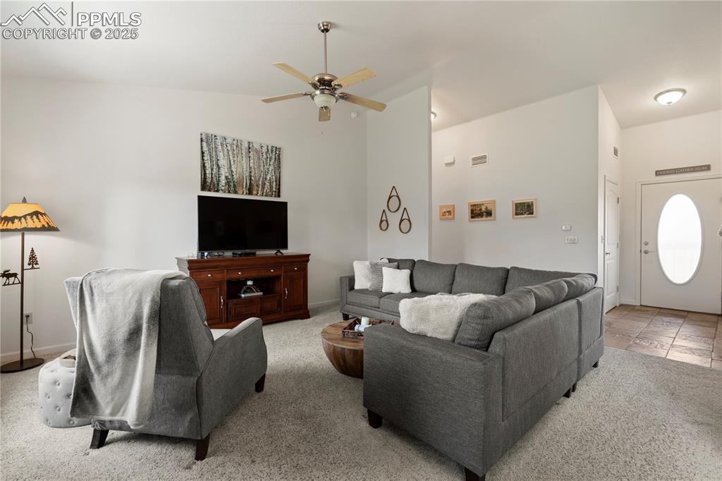 Image 14 of 27: The living room is the heart of the unit.